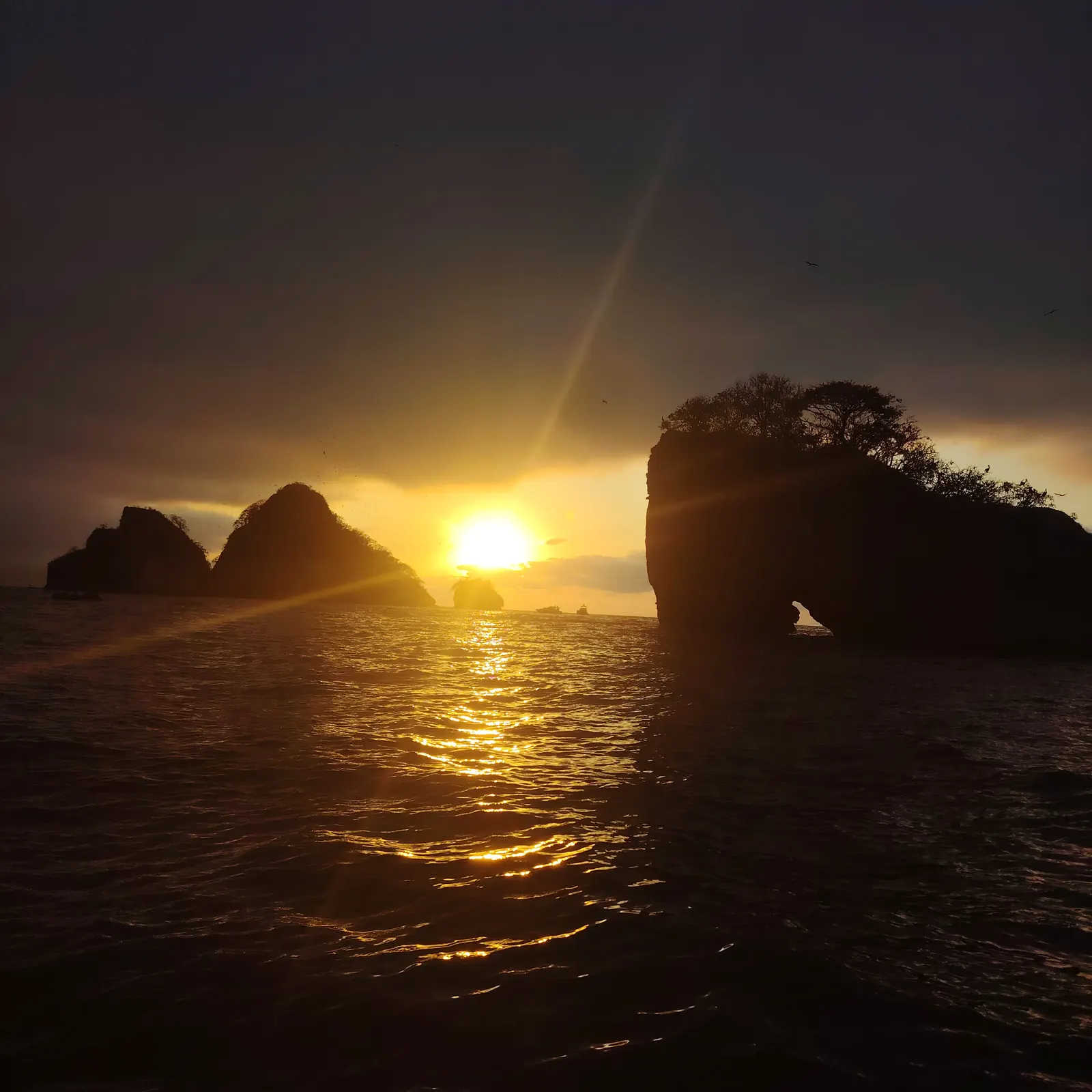 Sunset between the Los Arcos rocks off Mismaloya, Puerto Vallarta